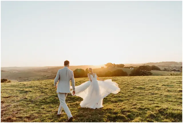 Marty & Nicola at Byron View Farm: The couple walk through a paddock in the evening light.